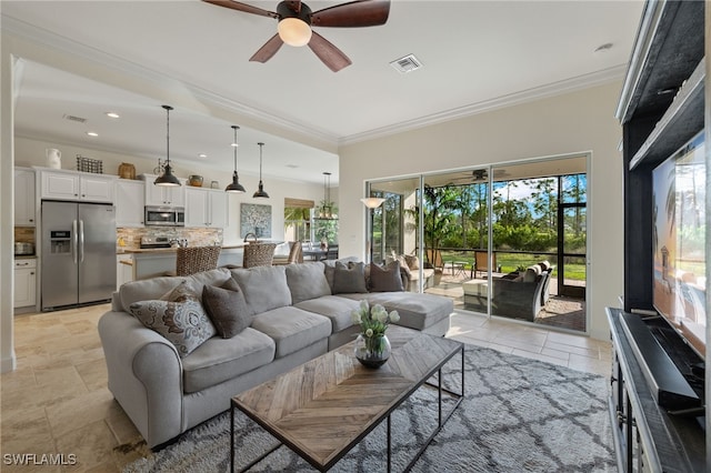 living area featuring a wealth of natural light, visible vents, and crown molding