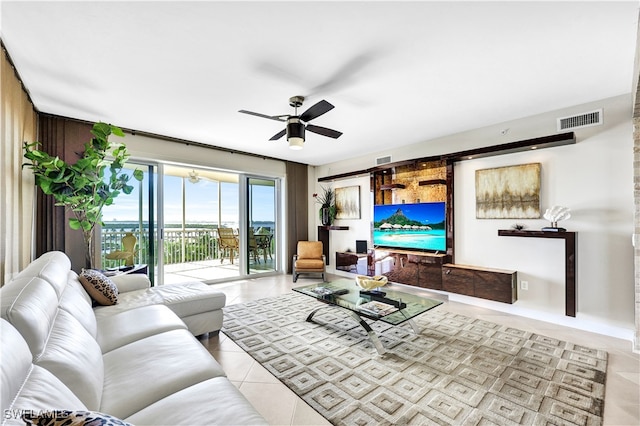 tiled living room with ceiling fan