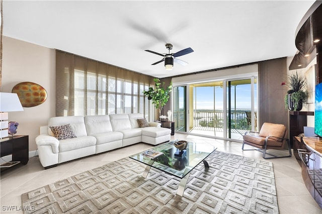 living room featuring light tile patterned floors and ceiling fan