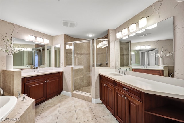 bathroom featuring vanity, shower with separate bathtub, and tile patterned floors