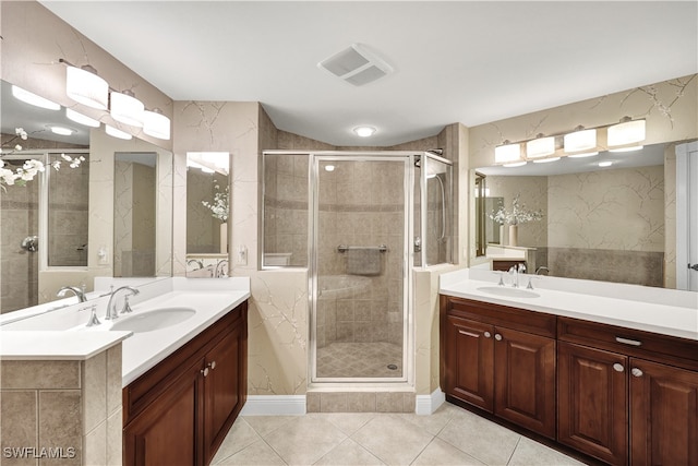 bathroom featuring walk in shower, tile patterned flooring, and vanity