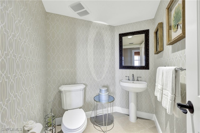 bathroom with tile patterned flooring, sink, and toilet