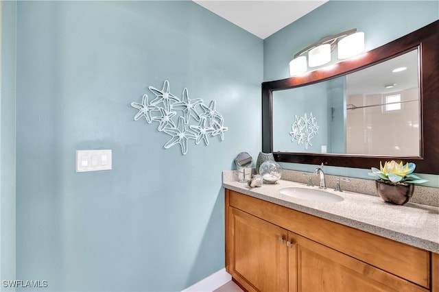 bathroom with walk in shower and vanity