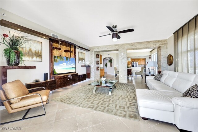 tiled living room featuring ceiling fan