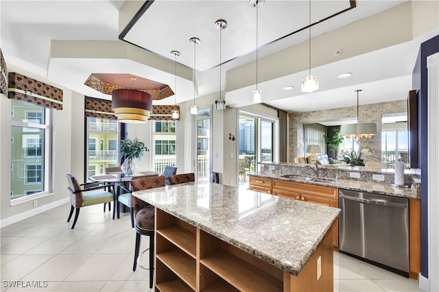 kitchen with a healthy amount of sunlight, sink, decorative light fixtures, and dishwasher