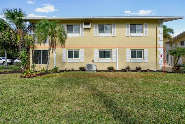 view of front of property with ac unit and a front lawn