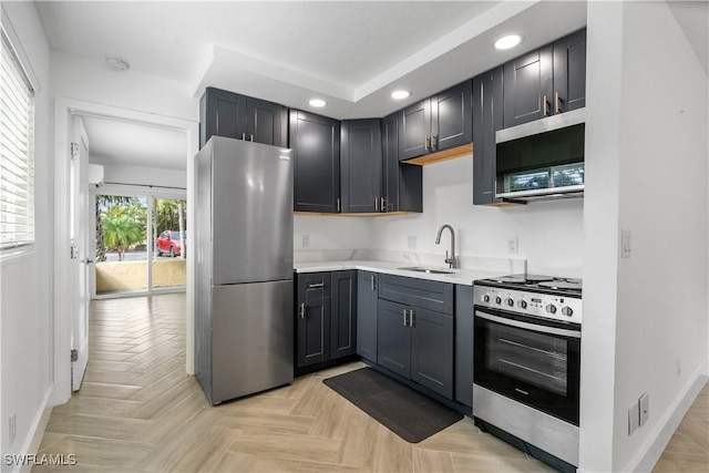 kitchen featuring light parquet floors, sink, gray cabinetry, and stainless steel appliances