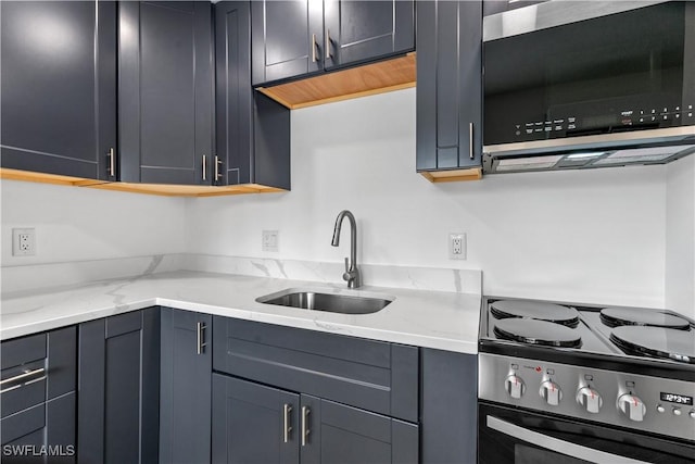 kitchen with stainless steel range with electric stovetop, light stone countertops, and sink