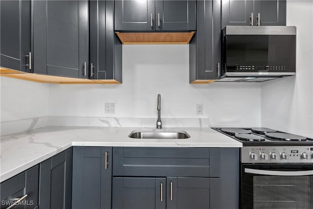 kitchen with stainless steel range oven, sink, and gray cabinets