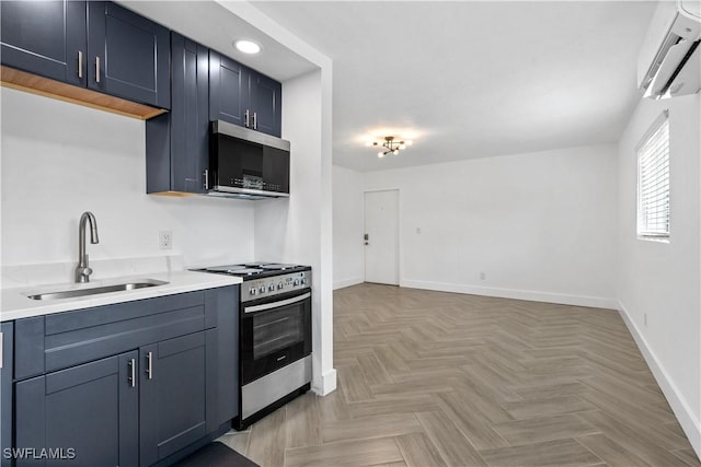 kitchen featuring an AC wall unit, sink, light parquet floors, and stainless steel appliances