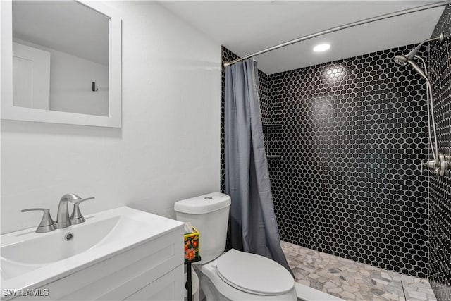 bathroom featuring toilet, vanity, and a shower with shower curtain