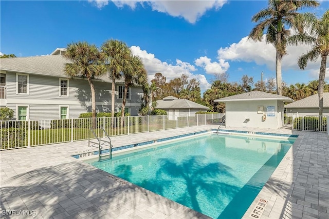 pool with fence and a patio