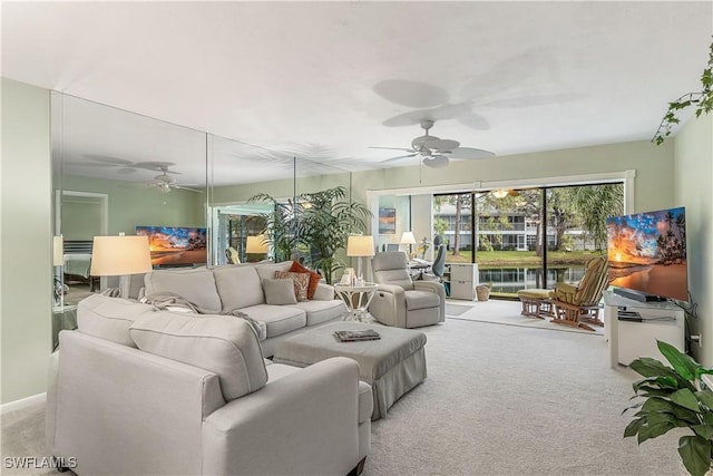 living area featuring ceiling fan and carpet flooring