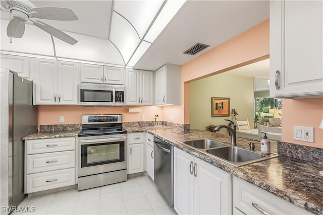 kitchen with visible vents, white cabinets, a ceiling fan, appliances with stainless steel finishes, and a sink