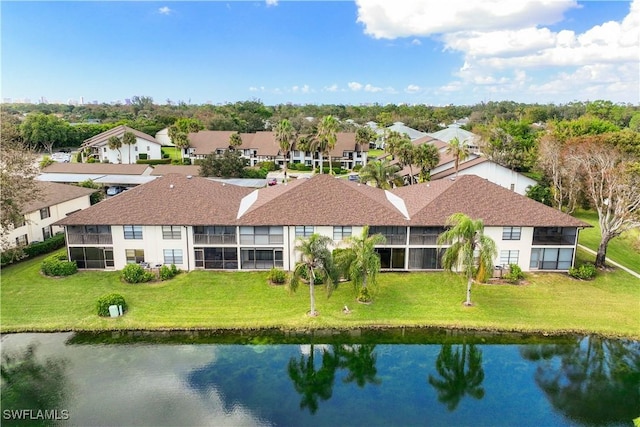 drone / aerial view featuring a water view and a residential view