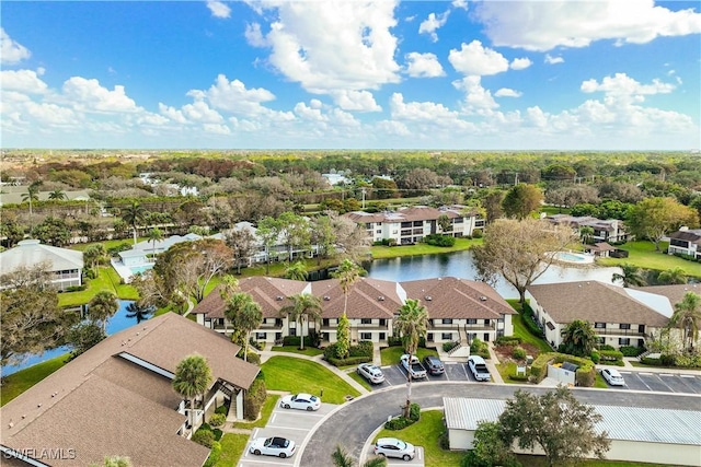 bird's eye view featuring a water view and a residential view