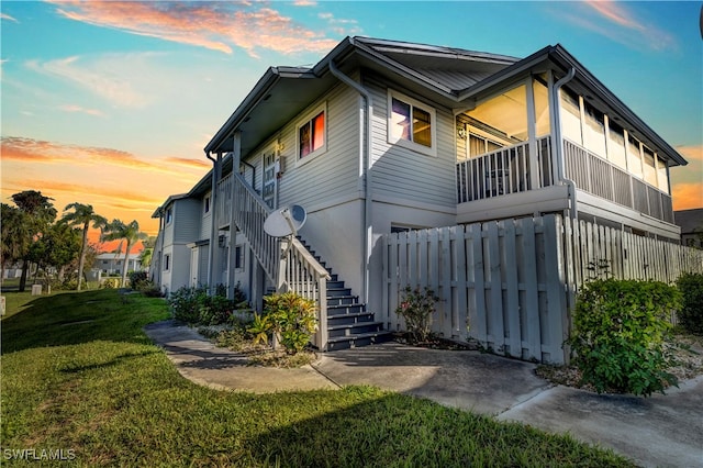 property exterior at dusk with a yard