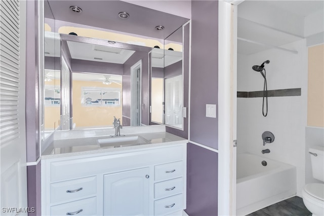 full bathroom featuring vanity, toilet, shower / bath combination, and ceiling fan