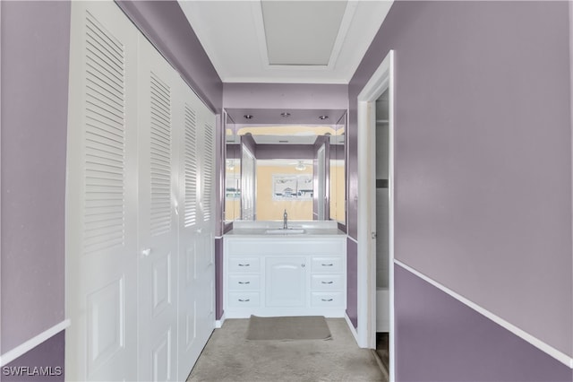 hall featuring light carpet and sink