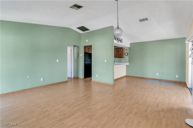 unfurnished living room with light hardwood / wood-style floors and vaulted ceiling