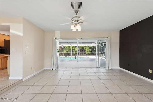 unfurnished room featuring ceiling fan and light tile patterned floors