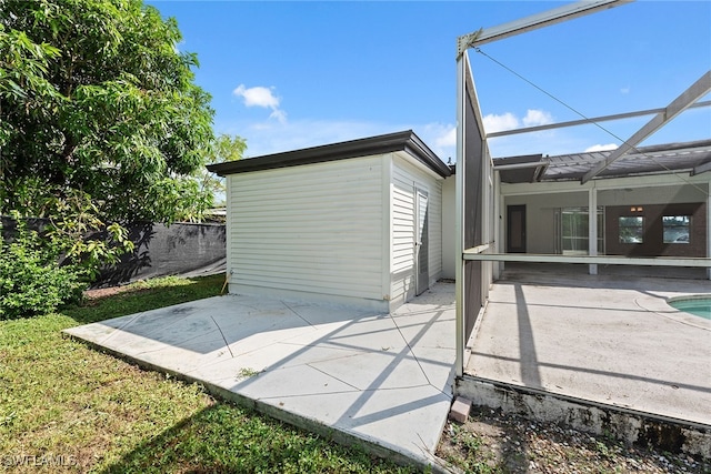 view of home's exterior with a patio area and a lanai