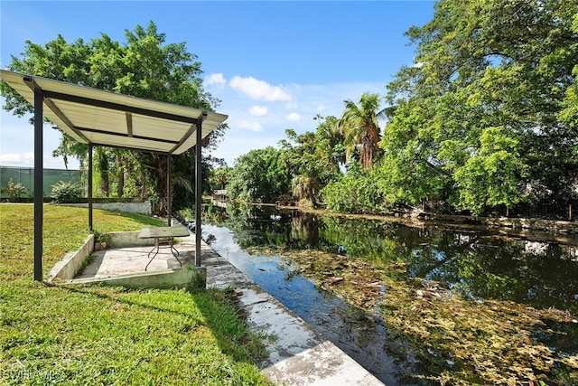 view of community featuring a water view and a lawn