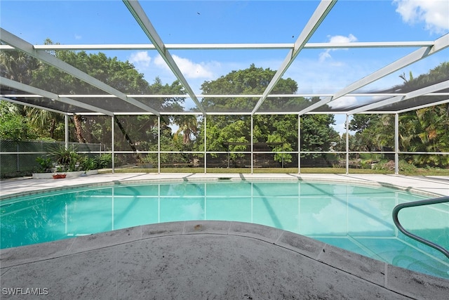 view of swimming pool featuring a patio area and a lanai