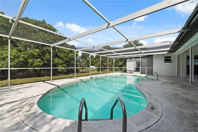 view of pool with a patio and glass enclosure