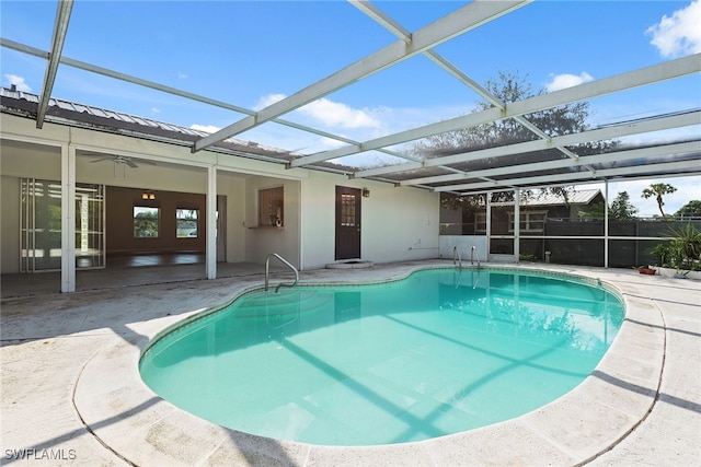 view of pool featuring a patio area, ceiling fan, and glass enclosure