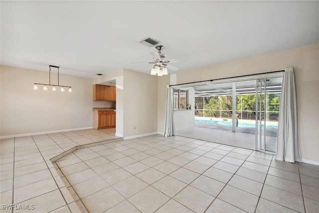 unfurnished living room with ceiling fan and light tile patterned floors