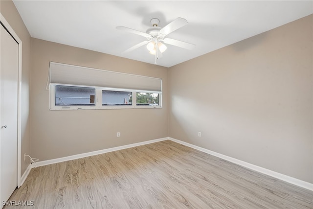 spare room featuring light hardwood / wood-style floors and ceiling fan