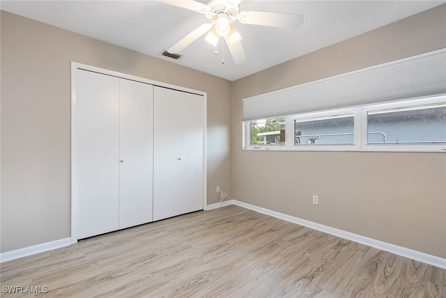 unfurnished bedroom featuring light hardwood / wood-style flooring, a closet, and ceiling fan