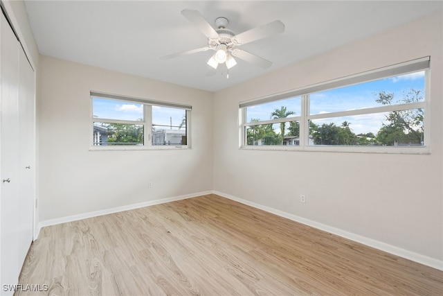 unfurnished room featuring light wood-type flooring and ceiling fan