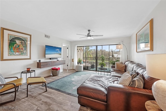 living room with light wood-type flooring and ceiling fan