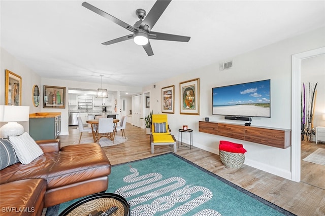 living room featuring light hardwood / wood-style floors and ceiling fan