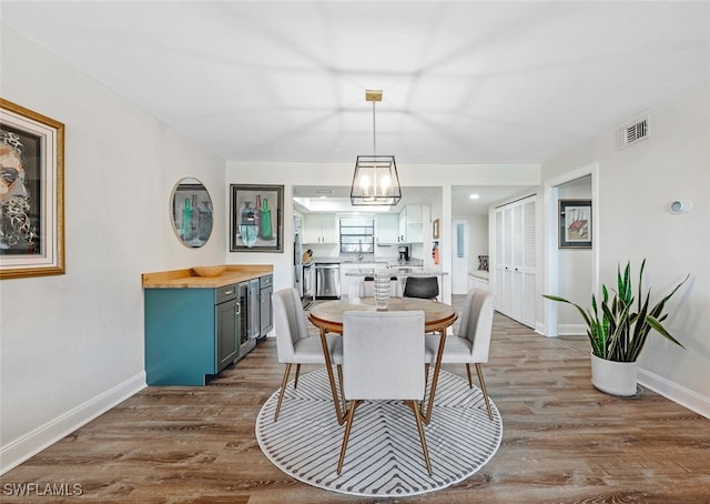 dining room with dark wood-type flooring and wine cooler