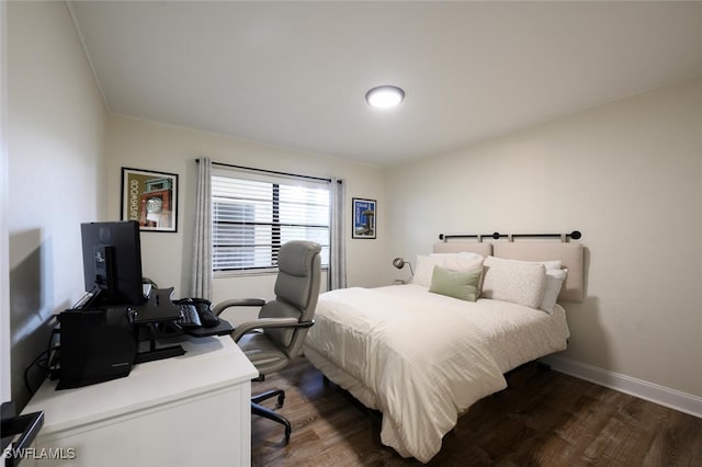 bedroom with dark hardwood / wood-style floors