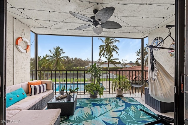 sunroom / solarium featuring ceiling fan