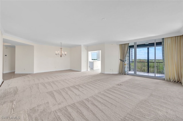 carpeted empty room with a notable chandelier and floor to ceiling windows