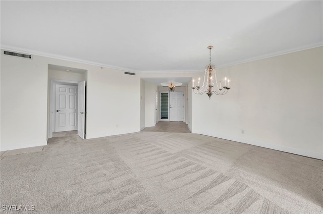 carpeted spare room with an inviting chandelier and ornamental molding