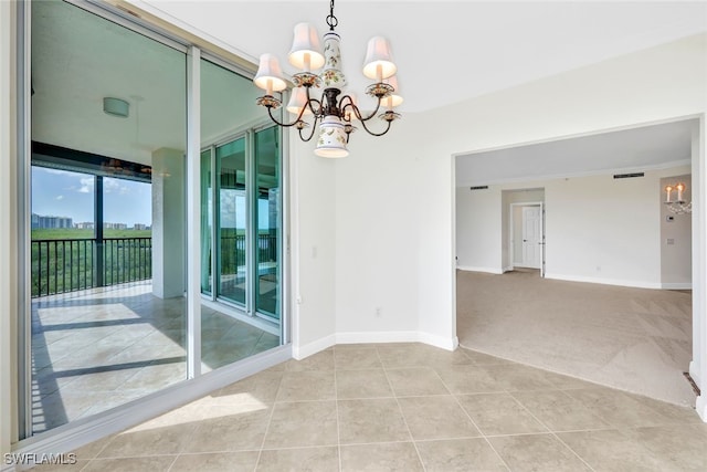 unfurnished room with a notable chandelier and light colored carpet