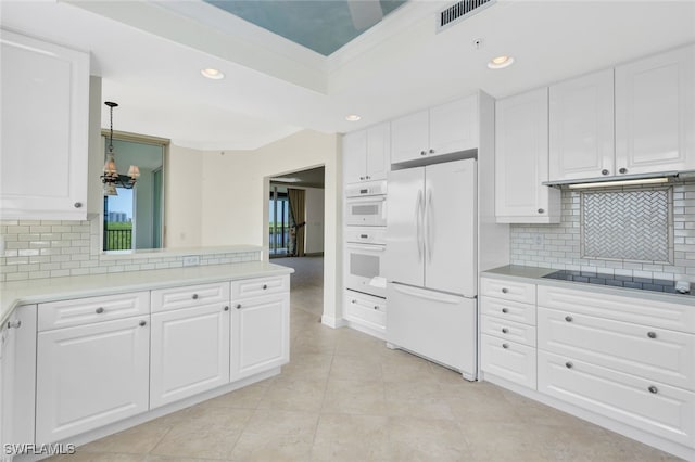 kitchen featuring white cabinetry, decorative light fixtures, backsplash, and white appliances