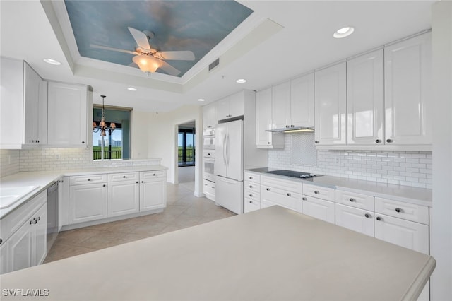 kitchen with white cabinetry, a barn door, dishwasher, pendant lighting, and white refrigerator