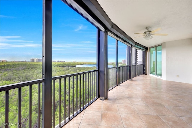 unfurnished sunroom with ceiling fan