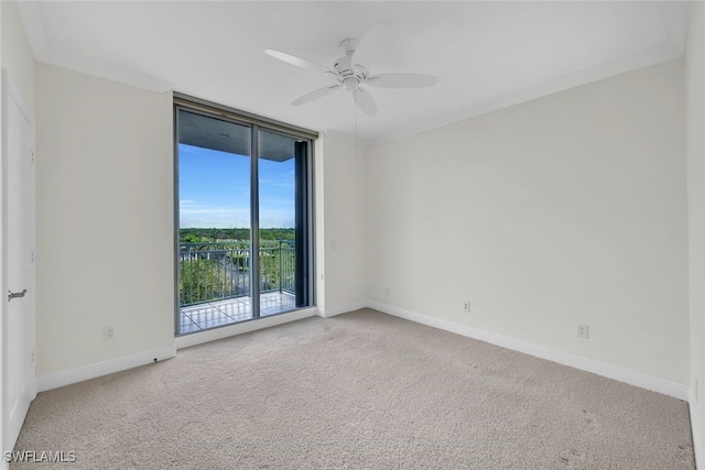 carpeted empty room with crown molding and ceiling fan