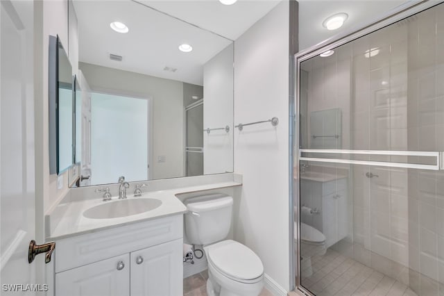 bathroom with toilet, walk in shower, and vanity