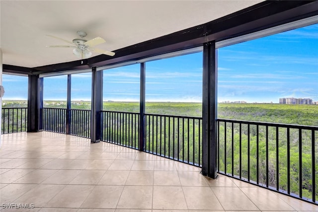 unfurnished sunroom featuring ceiling fan