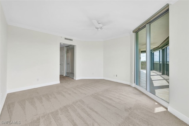 unfurnished room featuring crown molding, light colored carpet, and ceiling fan