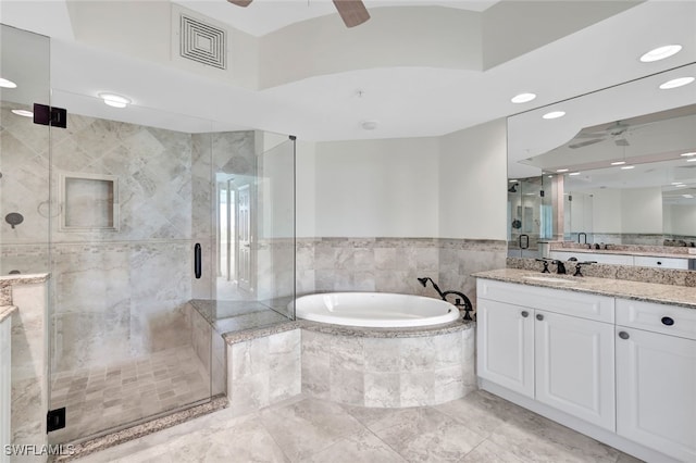 bathroom featuring vanity, plus walk in shower, tile walls, and ceiling fan